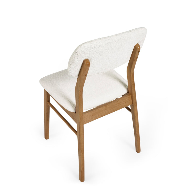 Chair with white cushioned backrest and seat on a white background