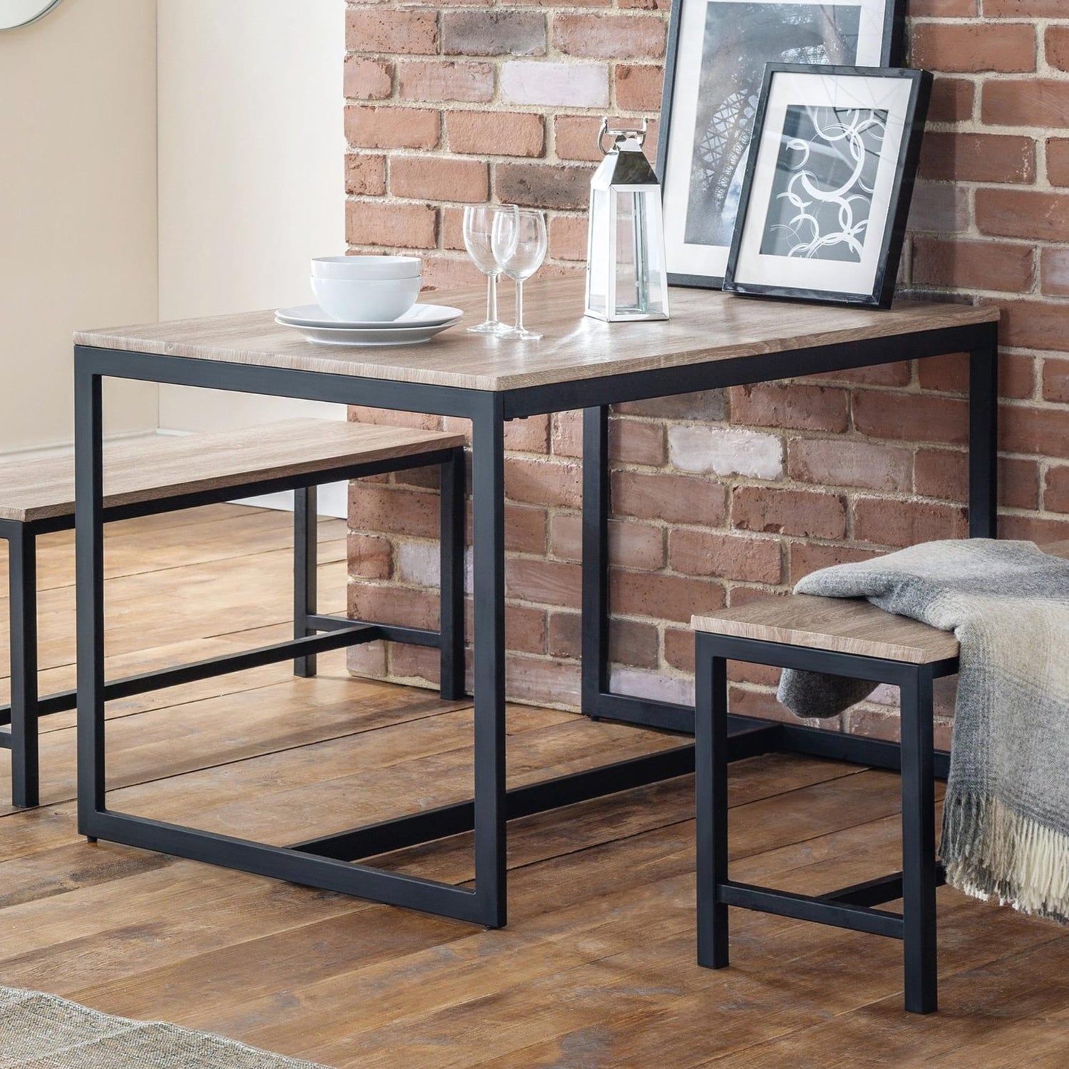 Dining table with chairs against a brick wall
