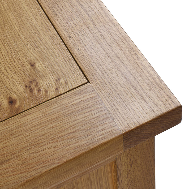Close-up of a wooden table corner with a white background