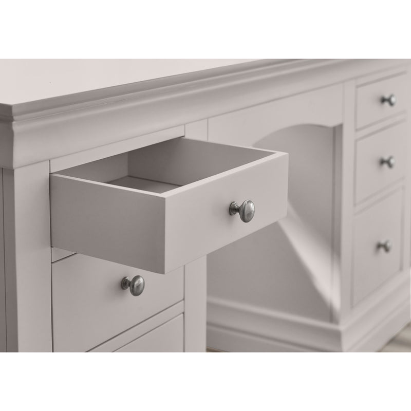 Gray dresser with open drawer and visible hardware