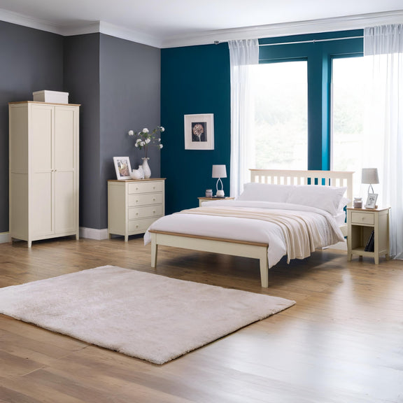 Neatly arranged bedroom with a bed, wardrobe, and dresser.