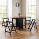 Black dining table with four matching chairs in a room with large windows.