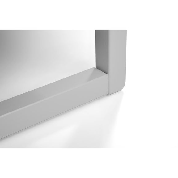 Close-up of a white rectangular object with a reflective surface on a white background