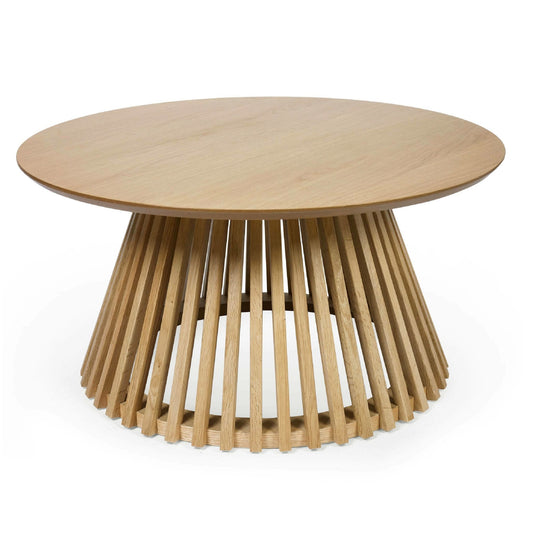 Wooden round table with a unique base design on a white background