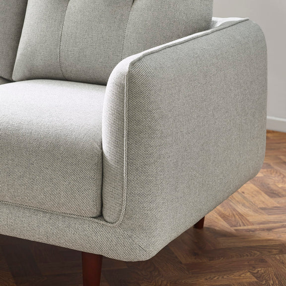 Gray upholstered chair on a wooden floor