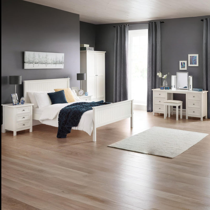Modern bedroom with white furniture, gray walls, and wooden flooring.