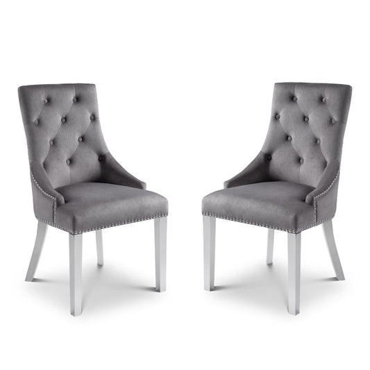 Two gray tufted chairs with silver legs on a white background