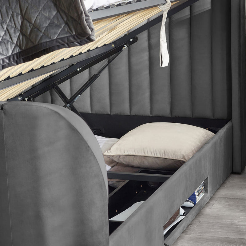 Gray bunk bed with a pillow and mattress in a compact living space.