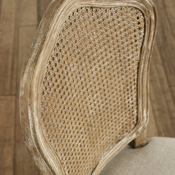 Close-up of a chair with wicker backrest and wooden frame.