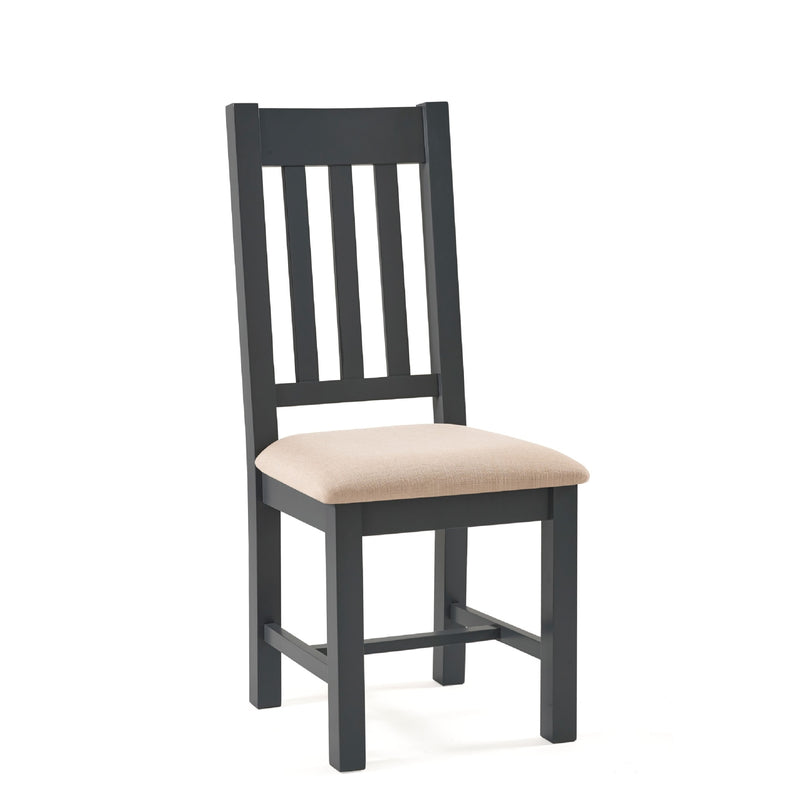 Dark wooden chair with a beige cushion on a white background