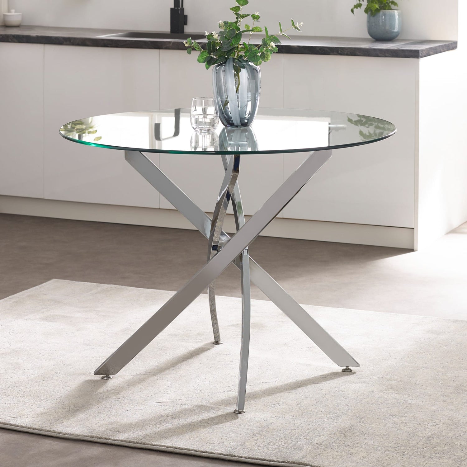 Glass dining table with metal legs in a kitchen setting