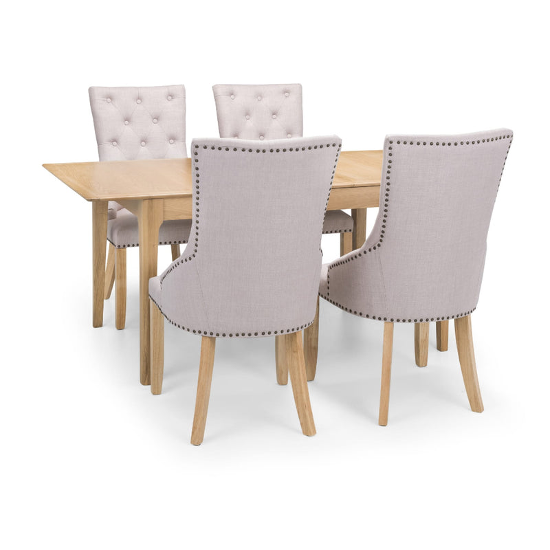 Dining table set with four gray upholstered chairs on a white background