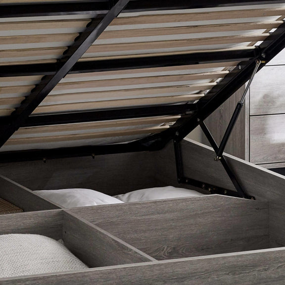 Wooden bed with open drawers revealing storage space underneath.