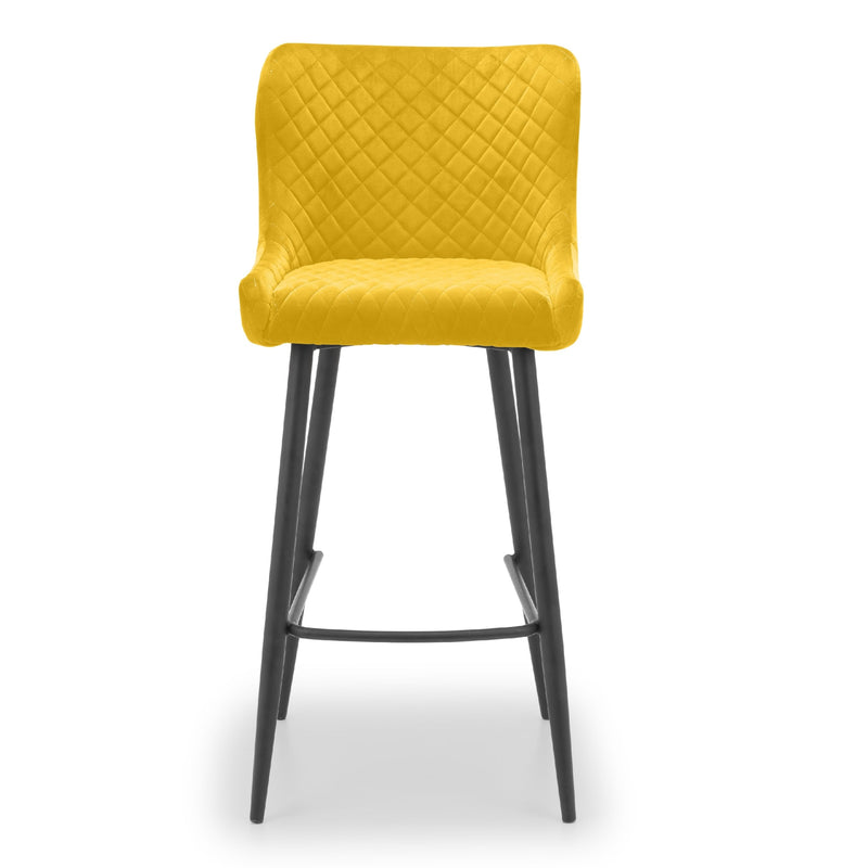 Yellow bar stool with quilted design on a white background