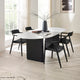 Modern dining room with a white oval table and black chairs.
