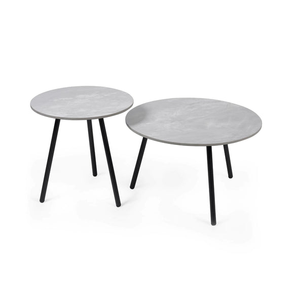 Two round side tables with a white marble-like top and black legs on a white background