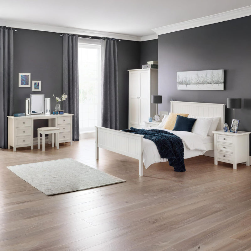 Modern bedroom with white furniture, gray walls, and wooden flooring.