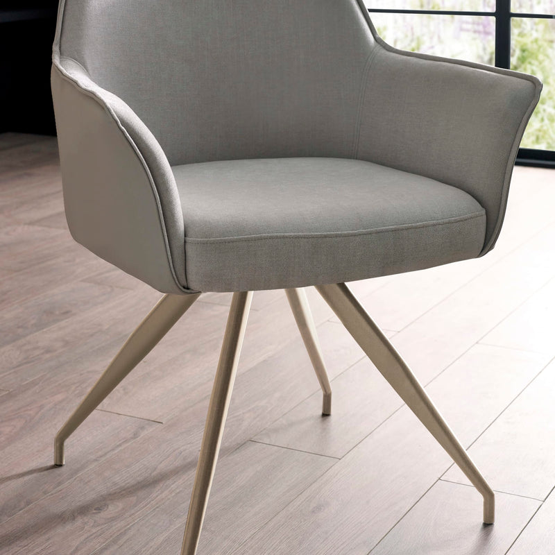 Gray armchair with beige legs on a wooden floor