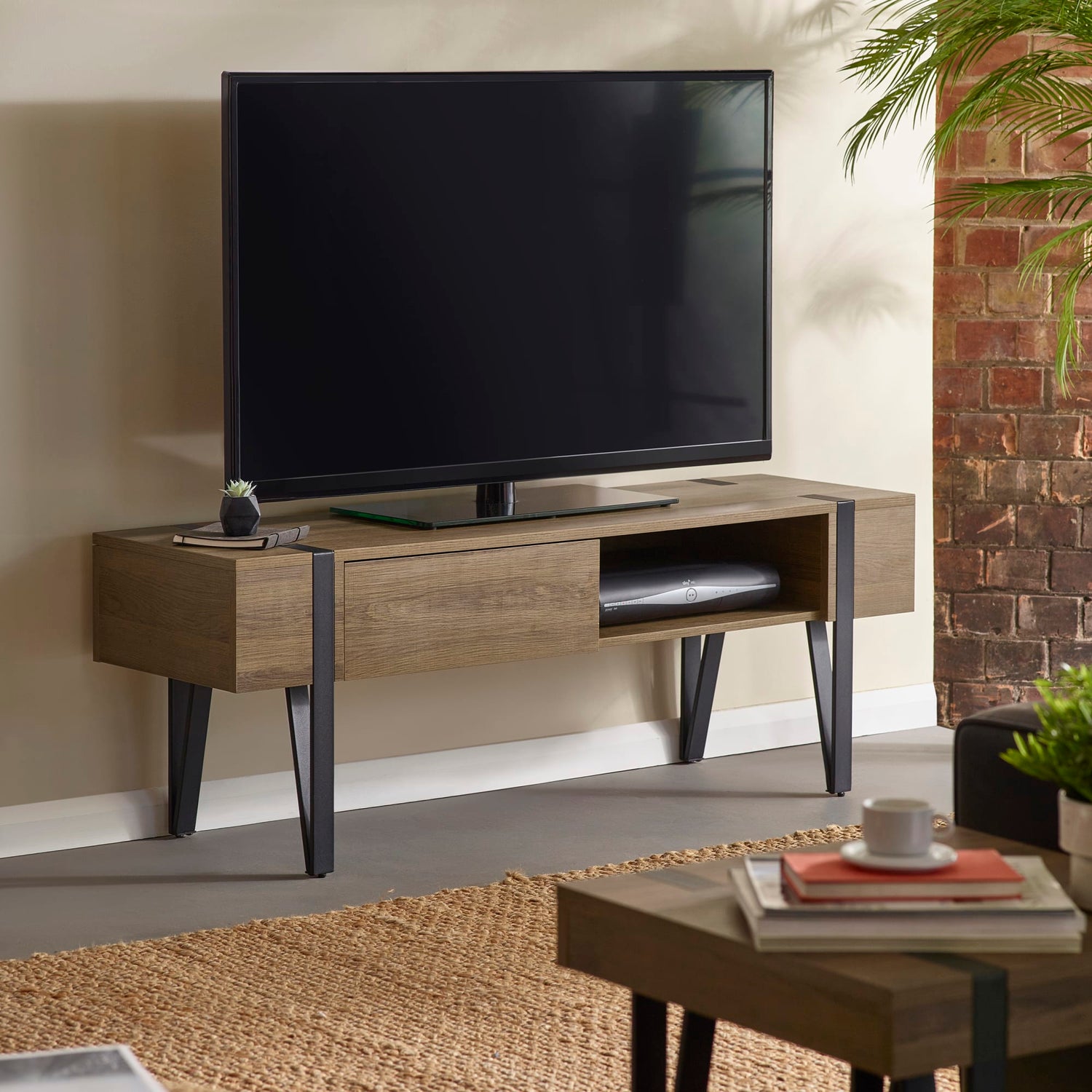 Wooden TV stand with a television in a living room setting.