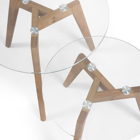Two glass tables with wooden legs on a white background