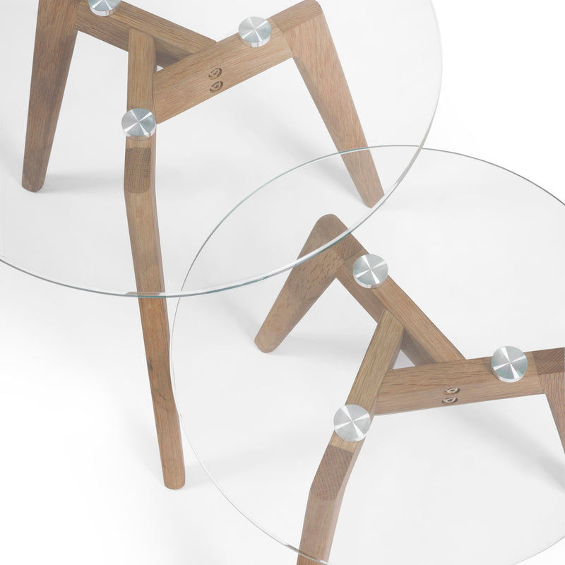 Two glass tables with wooden legs on a white background