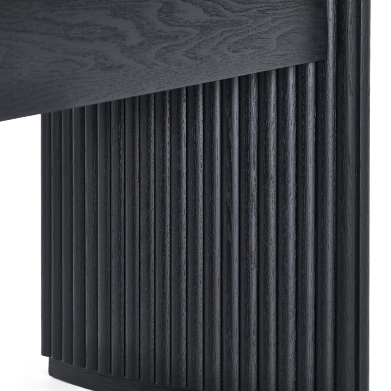Dark wooden side table with textured surface and ribbed design on a white background