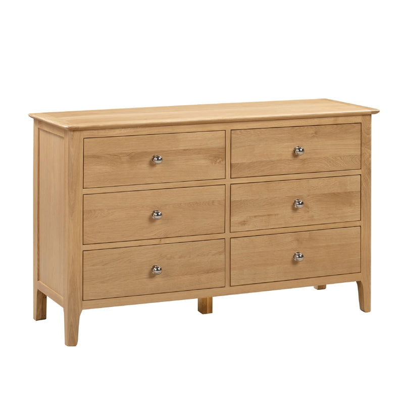 Wooden dresser with six drawers on a white background