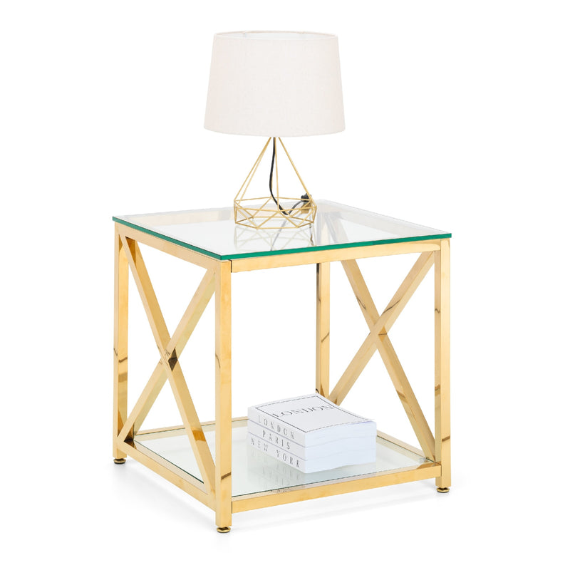 Gold side table with glass top and shelf, featuring a white lamp.