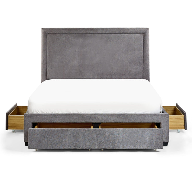 Gray upholstered bed with wooden drawers on a white background
