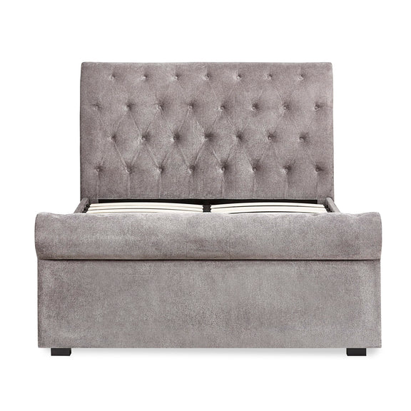 Gray upholstered bed with tufted headboard on a white background