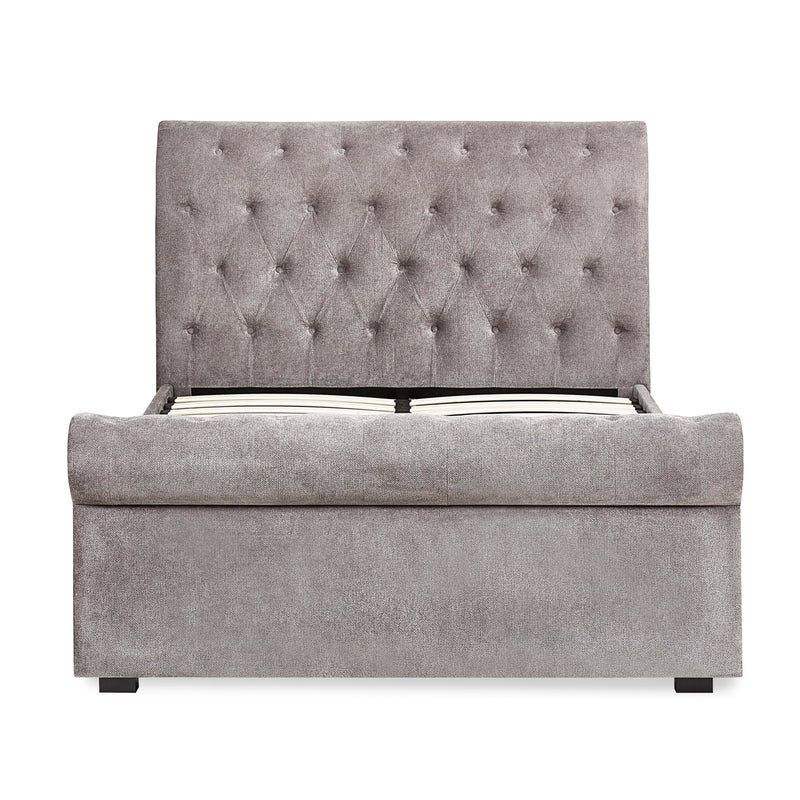 Gray upholstered bed with tufted headboard on a white background