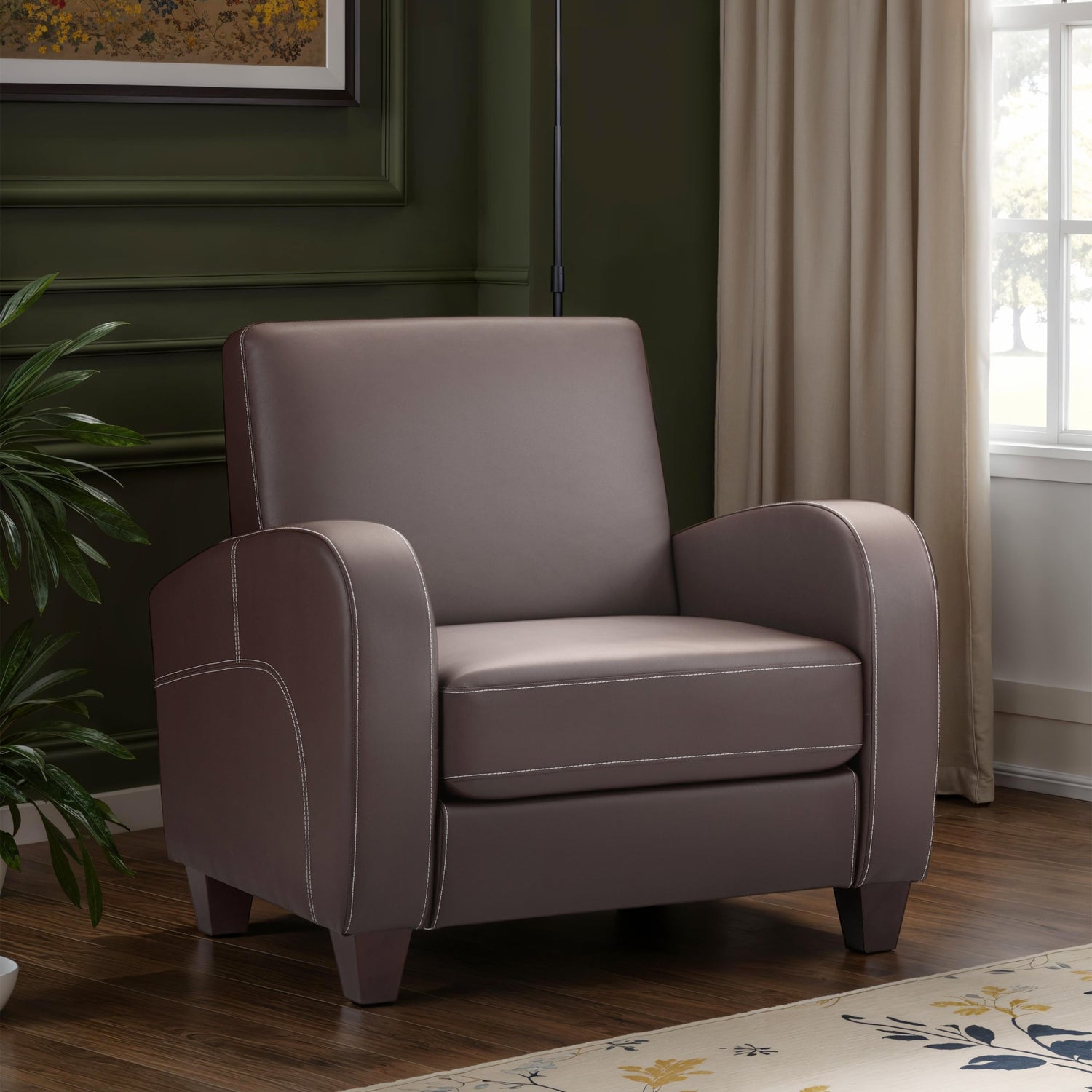 Gray armchair in a room with a plant and window