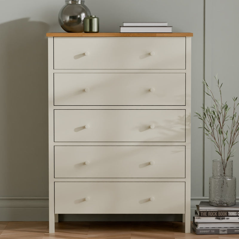 White dresser with wooden top against a neutral wall