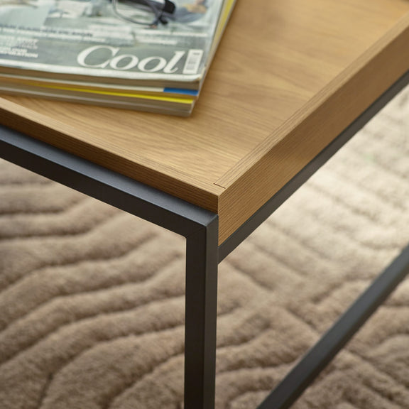 Wooden table with a magazine titled 'Cool' on a textured surface