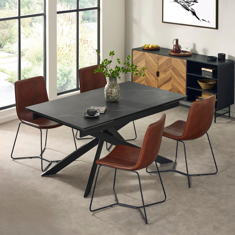 Dining room with a black table and brown chairs in a modern interior setting.