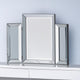 Three rectangular mirrors with silver frames on a white surface against a light blue wall.