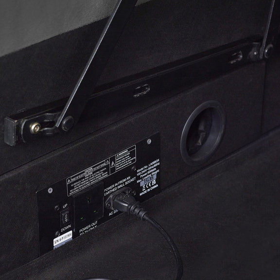Back panel of a black electronic device with power cable and labels.
