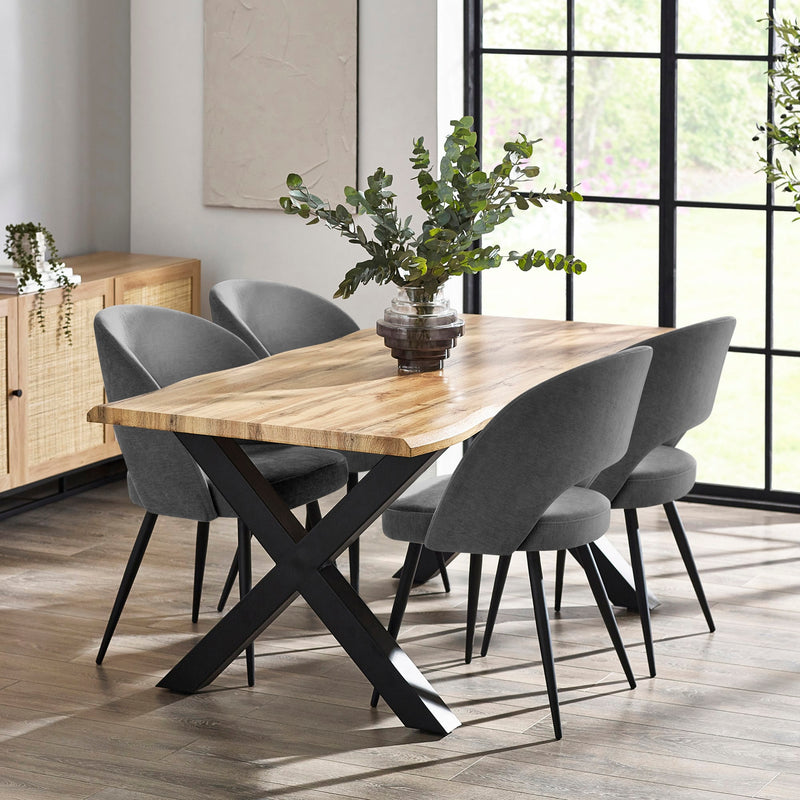 Dining room with a wooden table and gray chairs near a large window.