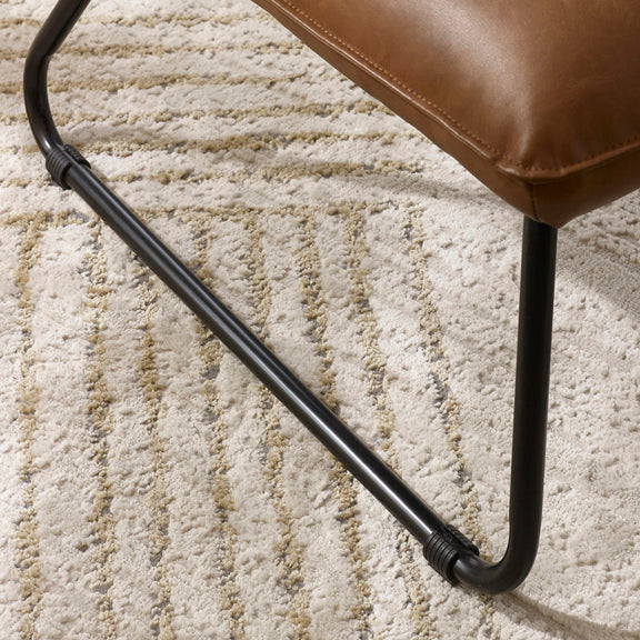 Brown chair with black metal legs on a textured beige carpet