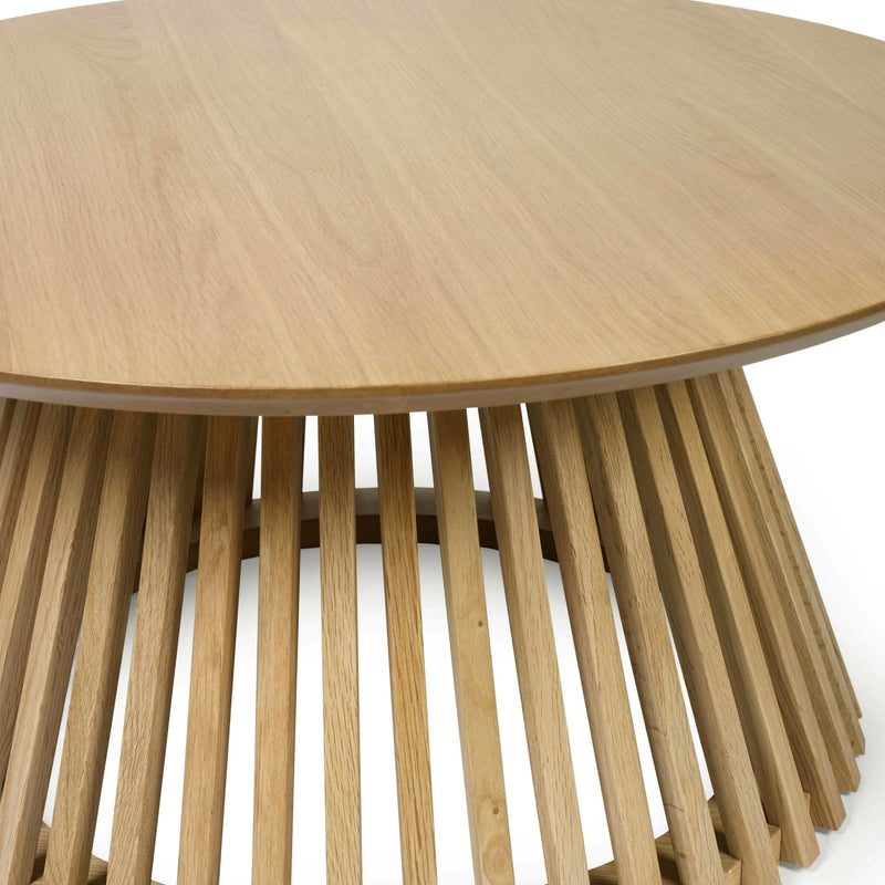 Wooden side table with a round top and slatted base on a white background