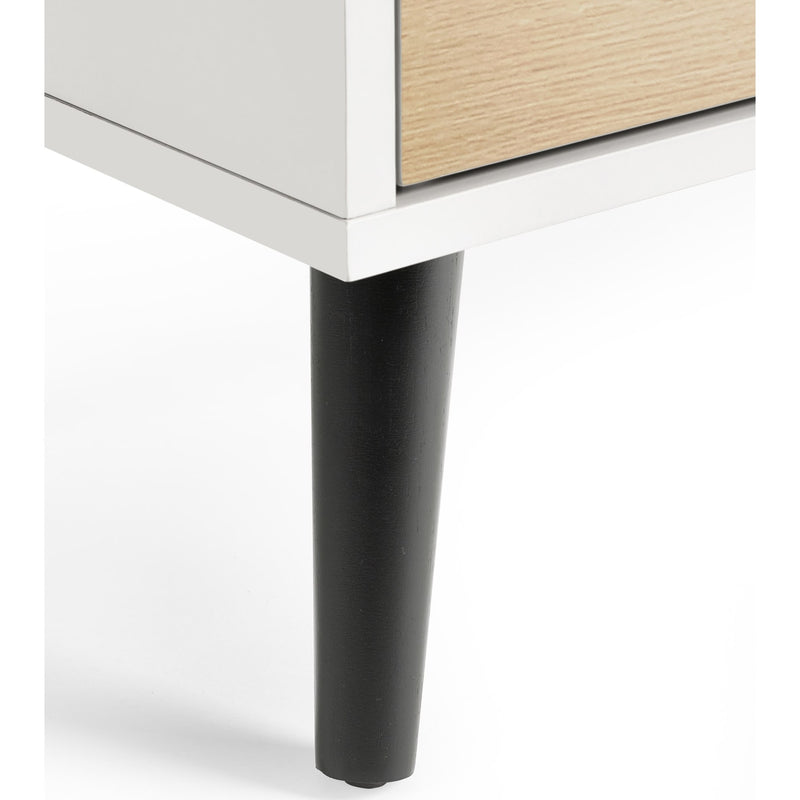 Close-up of a furniture leg on a white surface
