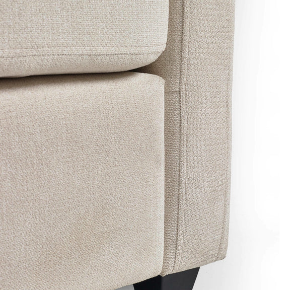 Close-up of a beige upholstered chair corner on a white background
