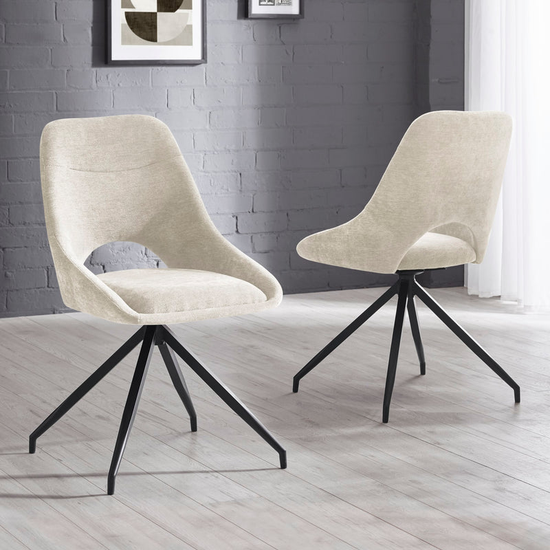Two beige chairs with black metal legs on a light wooden floor against a gray brick wall.