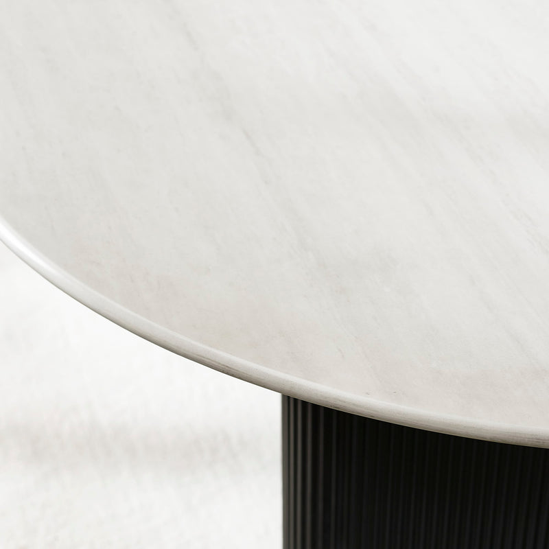 Close-up of a round white table with a black base on a white background