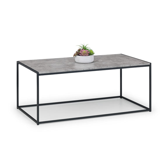 Coffee table with a concrete top and black metal frame on a white background