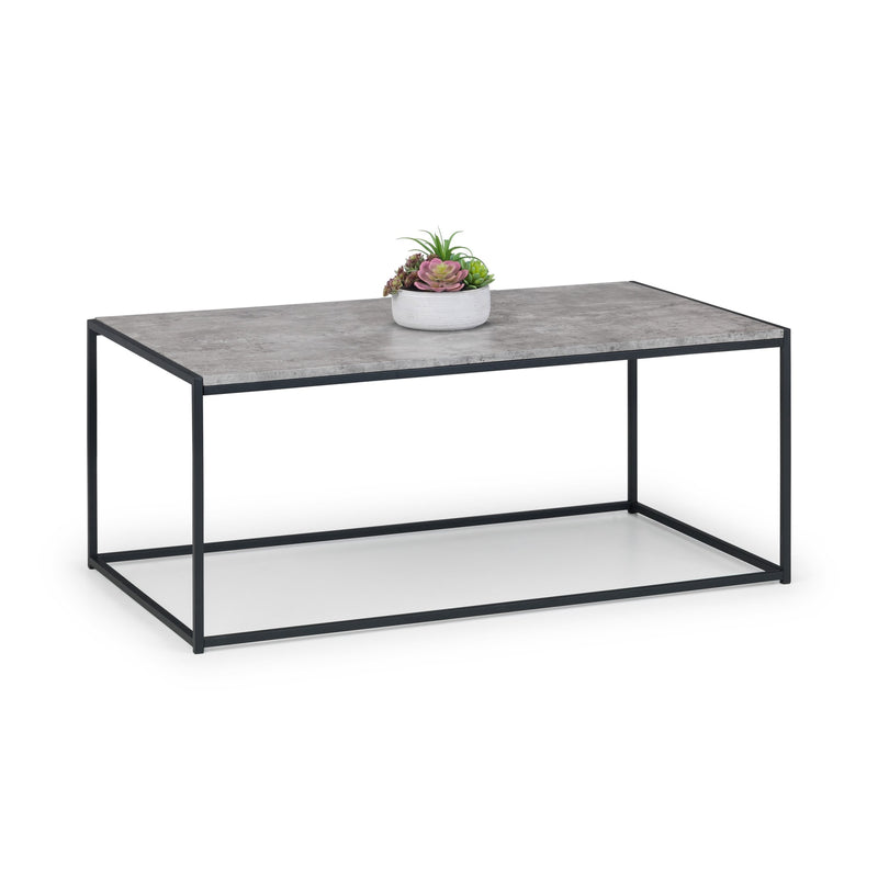 Coffee table with a concrete top and black metal frame on a white background