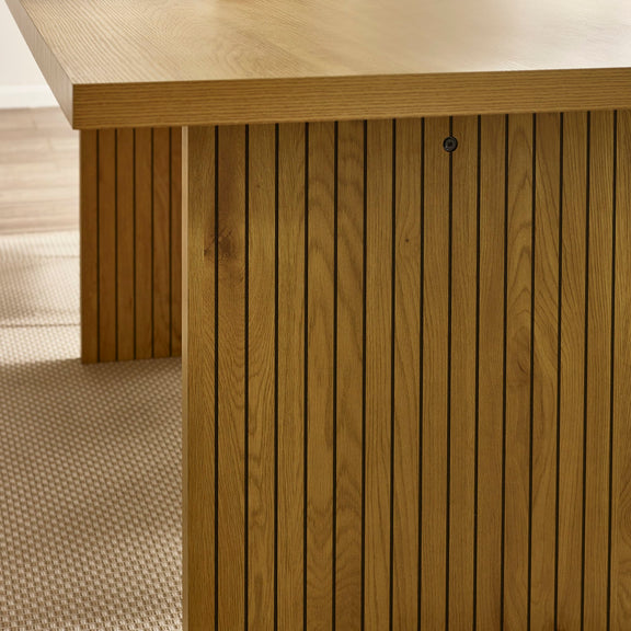 Close-up of a wooden deck with horizontal slats and a textured floor.