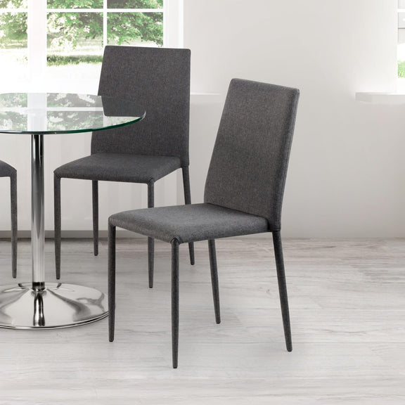 Gray upholstered chairs around a glass dining table in a bright room.