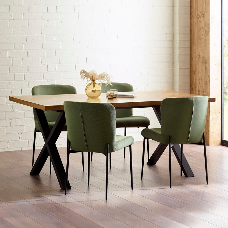 Dining table with green chairs in a modern interior setting