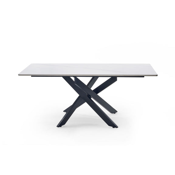 Modern dining table with white marble top and black metal legs on a white background